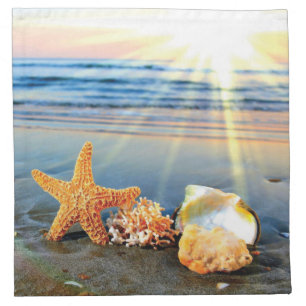Sea shells and starfish on beach cloth napkin