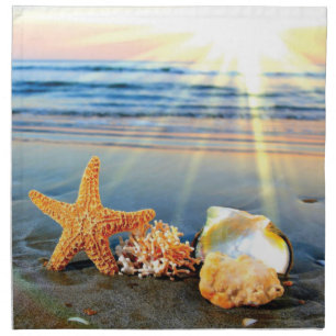 Sea shells and starfish on beach cloth napkin