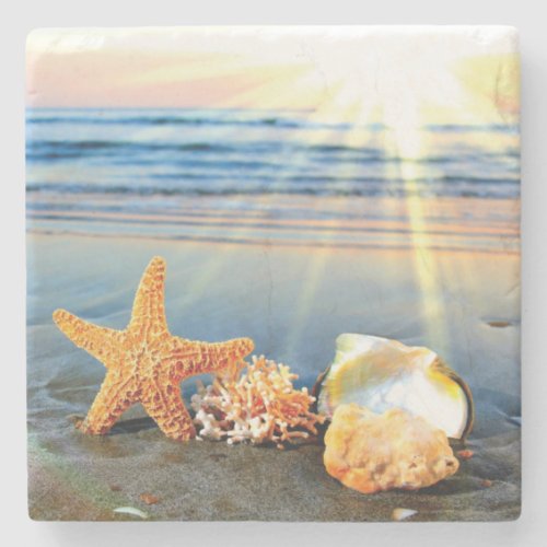 Sea shells and starfish on beach stone coaster