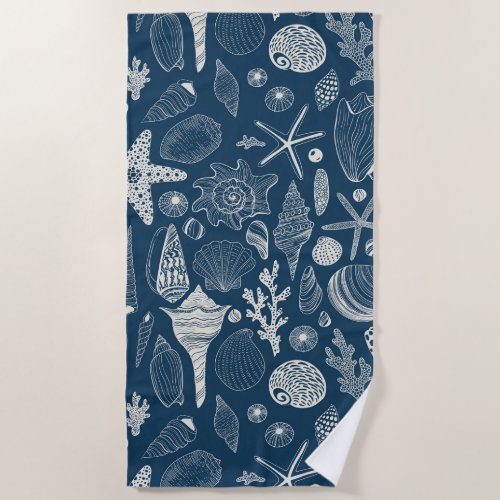 Sea shells on  dark blue beach towel