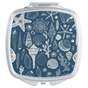 Sea shells on  dark blue compact mirror