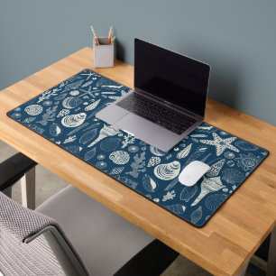 Sea shells on  dark blue desk mat