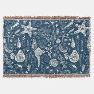 Sea shells on dark blue throw blanket