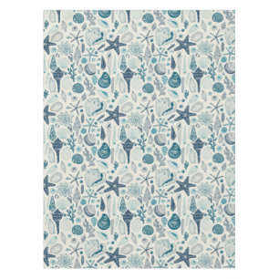 Sea shells on off white tablecloth