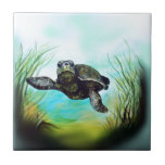 Sea Turtle Ceramic Tile<br><div class="desc">Surrounded by aquamarine waters, delicate lighting and warm green ocean plants, this sea turtle swims serenely through the water in a magical undersea adventure.</div>