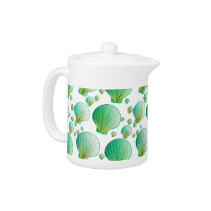 Seafoam green seashells on white teapot
