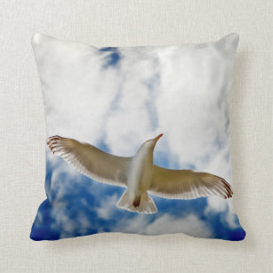 Seagul in flight with blue skies and white cloud, throw pillow