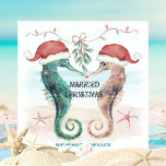Seahorse Beach Mistletoe Kiss Married Christmas Holiday Card<br><div class="desc">Coastal theme newlywed Christmas card features watercolor seahorses in Santa hats kissing under mistletoe on the beach with a "Married Christmas" caption. The holiday greeting and names can be personalized. Visit my "Seahorse Coastal Christmas Kiss" collection for coordinating invitations,  party supplies,  decor and more. Art by KL Stock.</div>