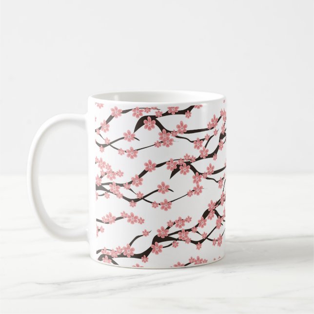 Seamless pattern with blooming cherry on a white b coffee mug (Left)