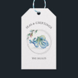 Seas and Greetings Favor Tags Watercolor Octopus<br><div class="desc">These Seas and Greetings beach wedding favor tags feature a watercolor octopus in shades of blue encircled by a string of Christmas lights. Use the template fields to add your custom thank you information in minimal text. A coastal choice for nautical themed holidays. Unique watercolor art and design by Victoria...</div>