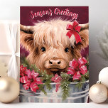 Season’s Greetings Highland Cow Christmas Card<br><div class="desc">Send warm holiday wishes with this charming card featuring a cute Highland cow adorned with festive bows and holiday greenery. The "Season's Greetings" message adds a joyful touch,  perfect for sharing festive cheer with friends and family who love unique and adorable holiday designs.</div>