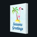 Seasons Greetings Pink Flamingo in Santa Hat Canvas Print<br><div class="desc">Wrapped canvas print with the text: Seasons Greetings. A whimsical drawing of a pink flamingo wearing a red santa hat. Standing on a mound of yellow beach sand with a green and brown coconut palm tree in the back. Light blue background with a faint polygonal pattern. Cute and fun festive...</div>