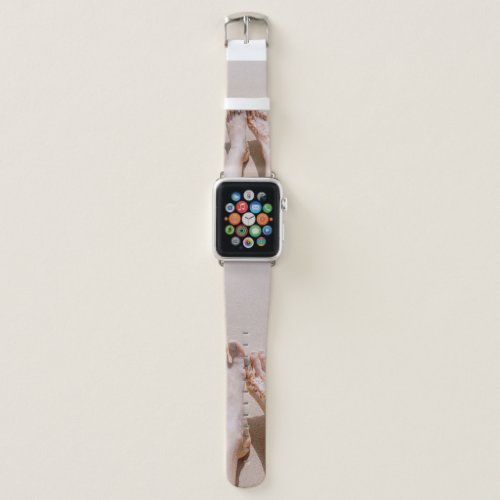 Selective focus photography of feet with tattoo on apple watch band