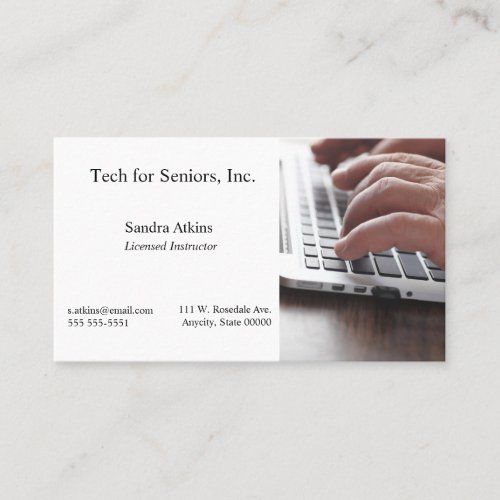 Senior man hands on laptop keyboard business card
