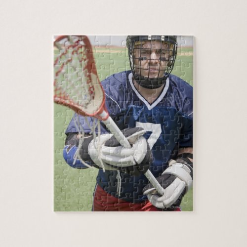 Serious lacrosse player holding crosse jigsaw puzzle