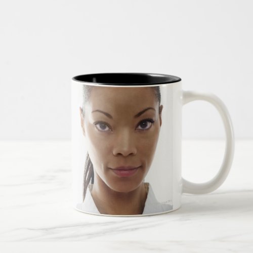 Serious woman doing martial arts Two_Tone coffee mug