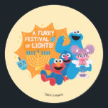 Sesame Street | A Furry Festival of Lights! Classic Round Sticker<br><div class="desc">Celebrate Hanukkah with your favorite Sesame Street friends in this delightful “A Furry Festival of Lights!” design! Featuring Cookie Monster, Elmo, Grover, and Abby Cadabby, this festive illustration captures the joy and warmth of the holiday season. Surrounded by a glowing menorah, playful dreidels, and cheerful smiles, this design is perfect...</div>