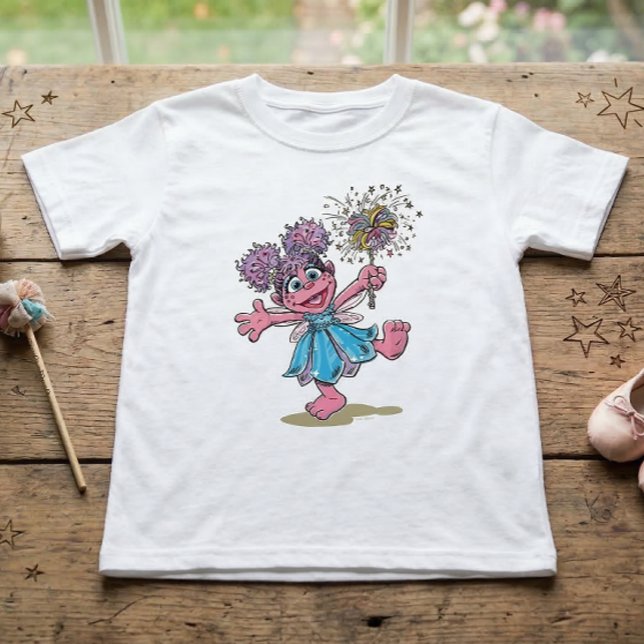Sesame Street Abby Cadabby Retro Art T-Shirt (Generated image of t-shirt on table)
