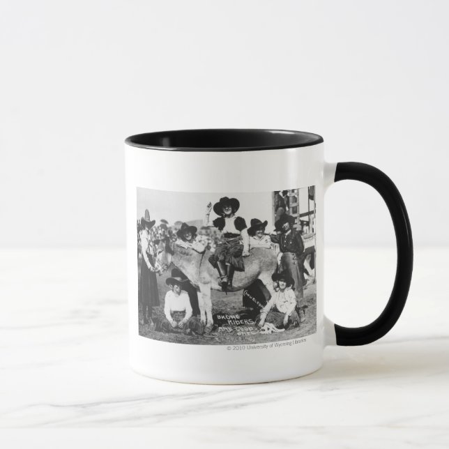 Seven rodeo cowgirls jokingly posing with a donkey mug (Right)
