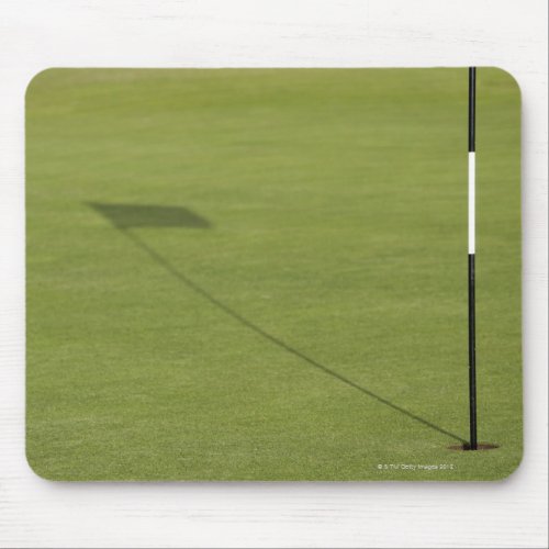 shadow of golf flag on golf course green mouse pad