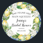 She Found Her Main Squeeze Lemon Bridal Shower Classic Round Sticker<br><div class="desc">Designed to coordinate with the Jenny's Lemon Collection, this bridal shower sticker features a yellow lemon and white floral wreath. There is a hint of the blue tiles around the edge of the round sticker. She Found Her Main Squeeze begins the bridal shower text. The bride's name and bridal shower...</div>