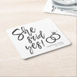 She Said Yes! | Engagement Party Script Lettering Square Paper Coaster<br><div class="desc">A fun and unique script-lettered coasters tailored specifically to your future engagement dinner or party.  It features the words "She Said Yes!" with wedding rings beside it. Underneath this and above it are the names of the bride and groom and the engagement or wedding date.</div>