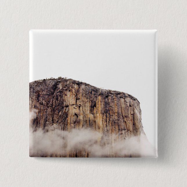 Sheer cliff rising above clouds button (Front)