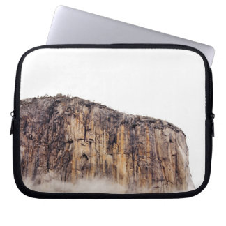Sheer cliff rising above clouds laptop sleeve