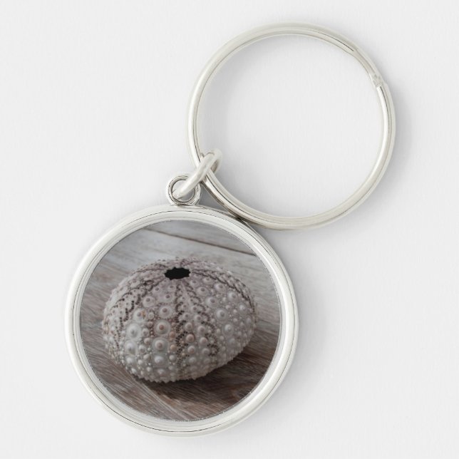 Shell On Top Of A Wooden Table Keychain (Front)