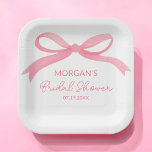 She's Tying The Knot Pink Bow Bridal Shower Paper Plates<br><div class="desc">Celebrate the bride-to-be with our "She's Tying The Knot" Pink Bridal Shower Paper Plates. Featuring a beautiful blush pink background with elegant script and a charming bow design, these plates add a sophisticated touch to your bridal shower decor. Made from high-quality, durable paper, they are perfect for serving appetizers, desserts,...</div>