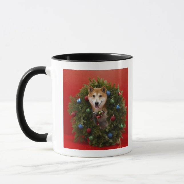 Shiba Inu dog sitting in Christmas wreath Mug (Left)