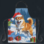 Shiba Inu Running in Snow with Christmas Hat Apron<br><div class="desc">A spirited Shiba Inu runs joyfully through the snowy winter scene,  wearing a festive red Christmas hat. This charming design highlights the breed’s foxlike face,  curled tail,  and confident personality while capturing the warmth and joy of the holiday season. A delightful winter moment full of festive cheer.</div>