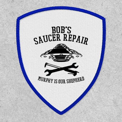 Shield patch with Bobs Saucer Repair logo