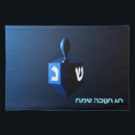Shiny Blue Dreidel Cloth Placemat<br><div class="desc">A modernistic,  metallic blue dreidel against a dark,  night-like background.  Two of the Hebrew letters found on a dreidel,  nun and shin,  glow brightly.  Hebrew text reading "Chag Chanukkah Sameach" (Happy Hanukkah) also appears in glowing blue and white.</div>