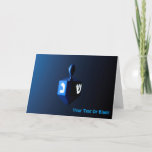 Shiny Blue Dreidel Holiday Card<br><div class="desc">A modernistic,  metallic,  blue dreidel against a dark,  night-like background.  Two of the Hebrew letters found on a dreidel,  nun and shin,  glow brightly. Add  your own text.</div>