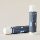 Shiny Blue Dreidel Lip Balm<br><div class="desc">A modernistic,  metallic,  blue dreidel against a dark,  night-like background.  Two of the Hebrew letters found on a dreidel,  nun and shin,  glow brightly.  English text reading "Happy Hanukkah" also appears in glowing blue and white.</div>