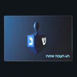 Shiny Blue Dreidel Placemat<br><div class="desc">On the front a modernistic, metallic blue dreidel against a dark, night-like background. Two of the Hebrew letters found on a dreidel, nun and shin, glow brightly. Hebrew text reading "Chag Chanukkah Sameach" (Happy Hanukkah) also appears in glowing blue and white. On the reverse side is the same image with...</div>