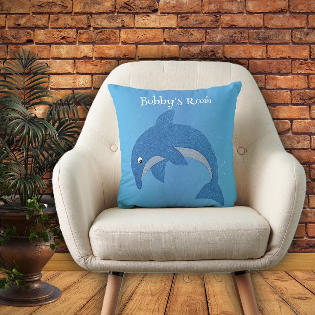 Shiny Cartoon Blue White Jumping Dolphin on Blue Throw Pillow (Bright blue throw pillow with cute jumping dolphin in dark blue and white for kids bedroom.)