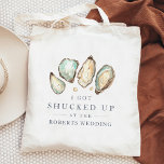 Shucked Up | Coastal Oyster Wedding Favor Tote Bag<br><div class="desc">These cheeky wedding favor tote bags feature a group of soft cream and aqua watercolor oyster and pearl illustrations, with "I got shucked up at the [name] wedding" in classic navy blue lettering. A perfect punny choice for beach themed, summer, or nautical weddings, you can easily personalize these coastal wedding...</div>