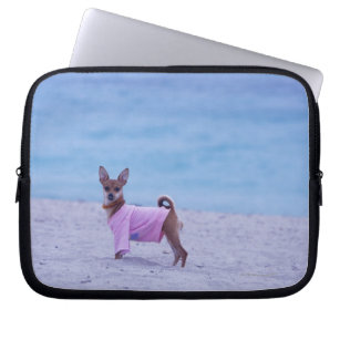 Side profile of a dog standing on the beach, laptop sleeve