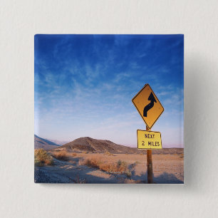 Sign on the death valley road in sunset pinback button