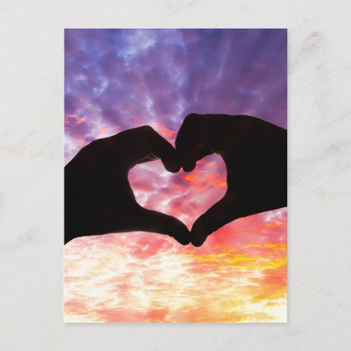 Silhouette hand in heart shape and beautiful sky postcard