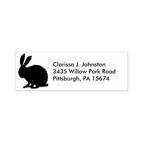 Silhouette in black of a fuzzy sitting bunny  self_inking stamp