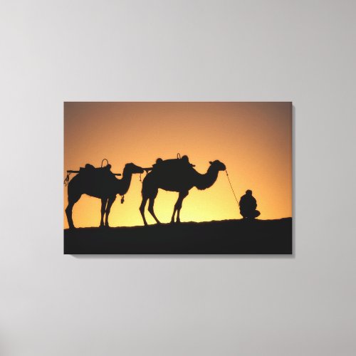 Silhouette of camel caravan on the desert at 2 canvas print