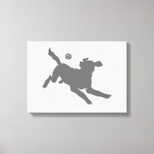 Silhouette of dog with ball canvas print