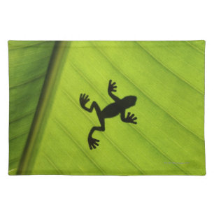Silhouette of frog through banana leaf placemat