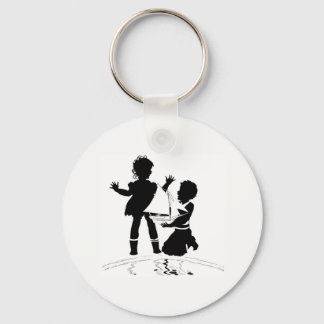 silhouette of girl and boy and model boat keychain