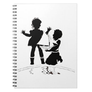 silhouette of girl and boy and model boat notebook