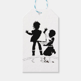 silhouette of girl and boy and toy boat gift tags