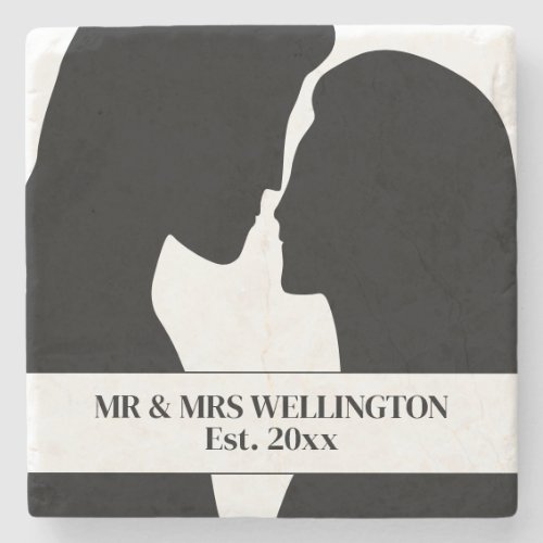 Silhouette of man and woman romantically kissing stone coaster
